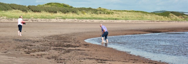 54 wading Pow Burn, Ruth hiking the Ayrshire Coastal Path