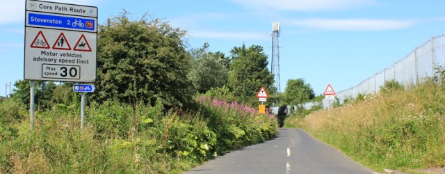 15 through industrial estate, Stevenston, Ruth hiking the Ayrshire Coast Path, Scotland