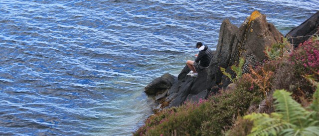 16 boy fishing on rocks, Clauchlands Point, Ruth walking the Arran Coastal Way