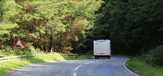 08 road twisting down, Ruth walking the shore of Loch Carron