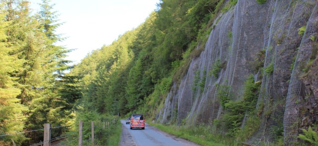 14 mesh over rocks, A890, Ruth walking the shore of Loch Carron