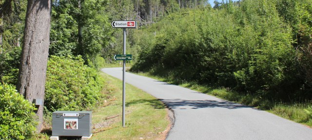 24 main road and sign to Duncraig station, Ruth hiking round the coast of Scotland