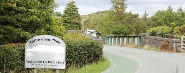 37 welcome to Plockton sign, Ruth walking the coast of the Scottish Highlands