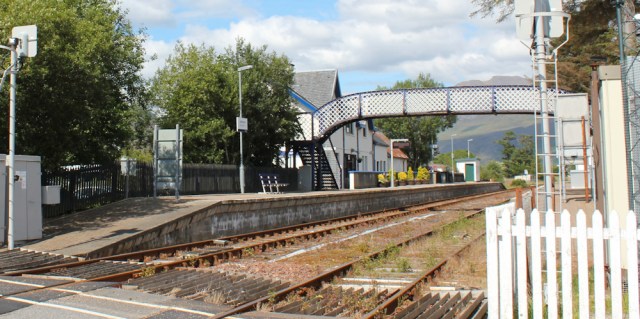 66 Strathcarron station, Ruth walking the shore of Loch Carron