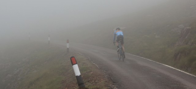 31 cyclist near the top, in the mist, Bealach na Ba, Ruth's coastal walk Scottish Highlands