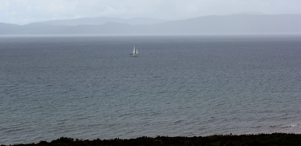 03 sailing ship and rain clouds, Ruth walking up the coast of Applecross, Scotland