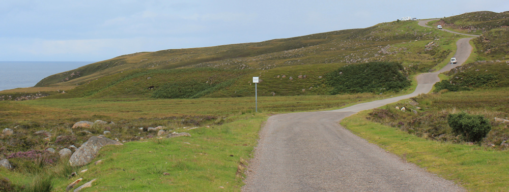25 up the hill to the viewpoint near Cuaig, Ruth walking up the coast of Applecross, Scotland