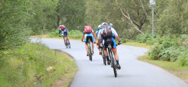 27 touring cyclists in lycra, Ruth walking the south bank of Loch Torridon, Scotland