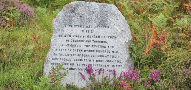 019a commemoration stone by side of road, Ruth walking the coast of north-west Scotland